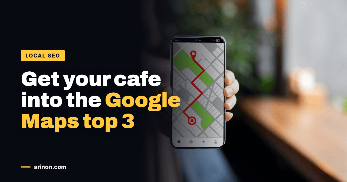 Hand holding a smartphone showing a Google Maps route in a cafe