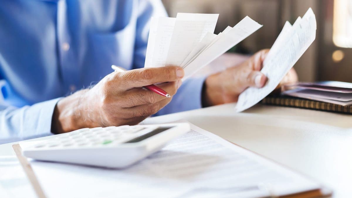 Accountant checking a pile of receipts with a calculator