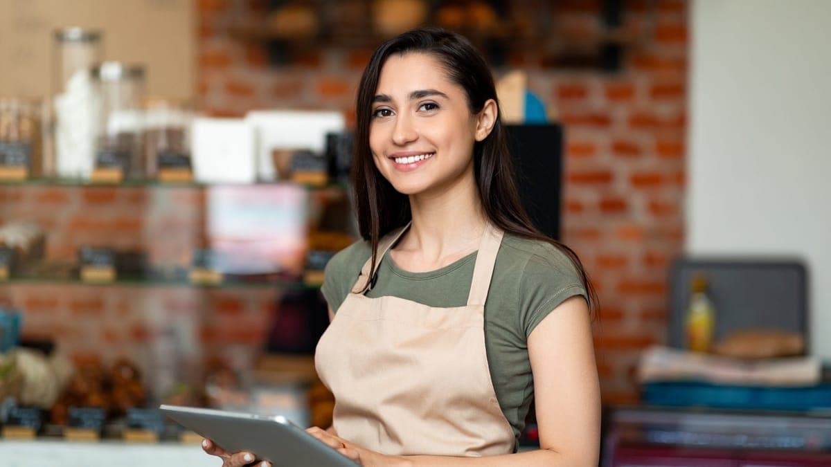 Small business owner opening the doors of her shop
