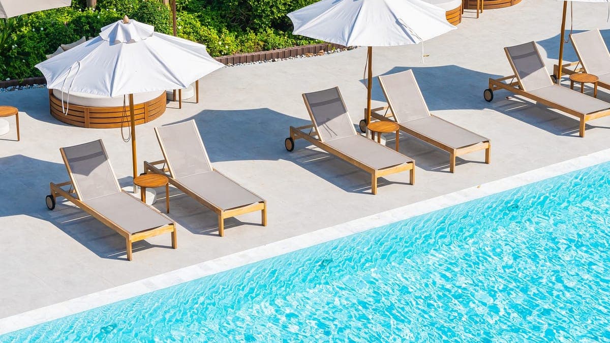 Sun loungers and umbrellas beside a resort swimming pool