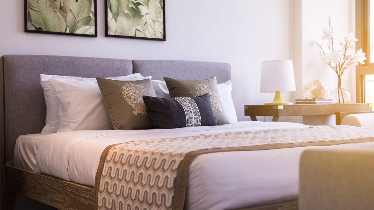 Modern hotel bedroom with a made double bed