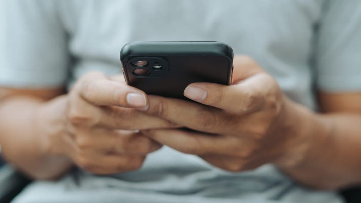Person scrolling a social media feed on a smartphone