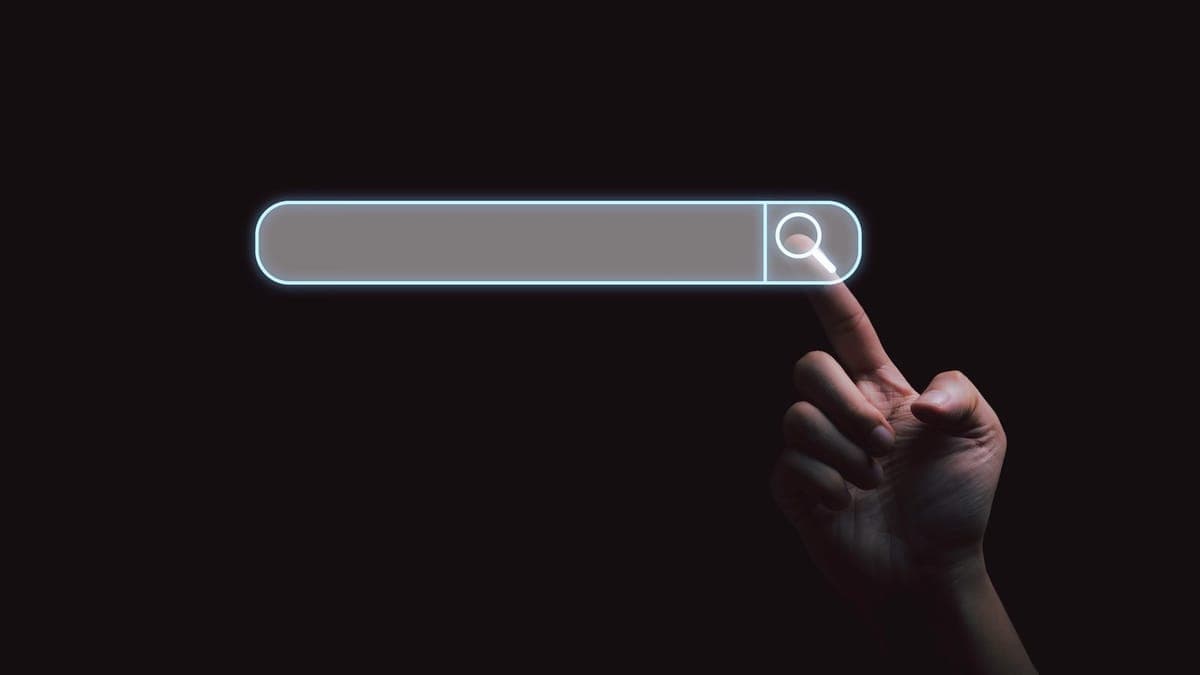 Hand touching a search icon on a virtual screen