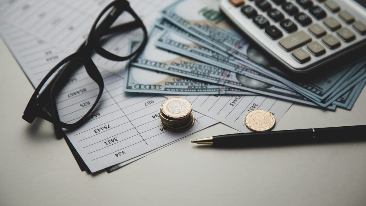 Calculator and cash on a desk while planning a marketing budget